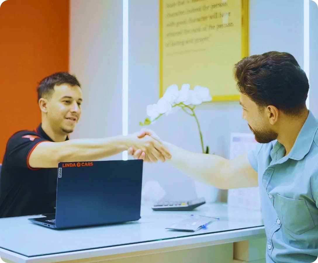 linda cars employee and customer shaking hands